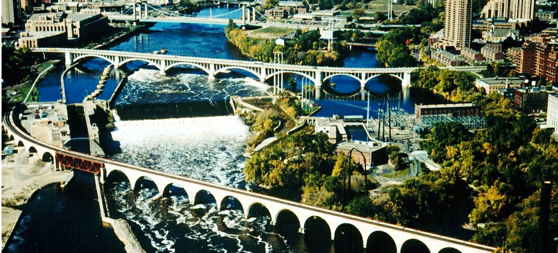 The Stone Arch Bridge is a former railroad bridge crossing the Mississippi River at Saint Anthony Falls in downtown Minneapolis, Minnesota. 117 Portland Avenue is the general address of the historic complex. 